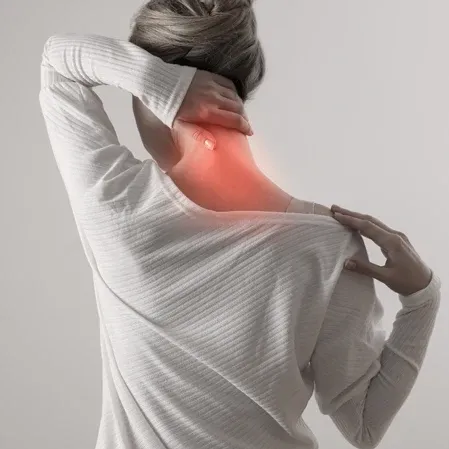 Person grasping the neck as an area of inflammation is highlighted, indicating cervical pain.